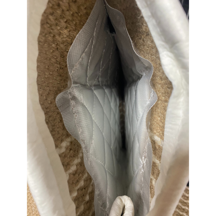 Close-up interior view of RADDOG jute sleeve showing quilted padding, reinforced lining, and narrow bite channel for protection training.