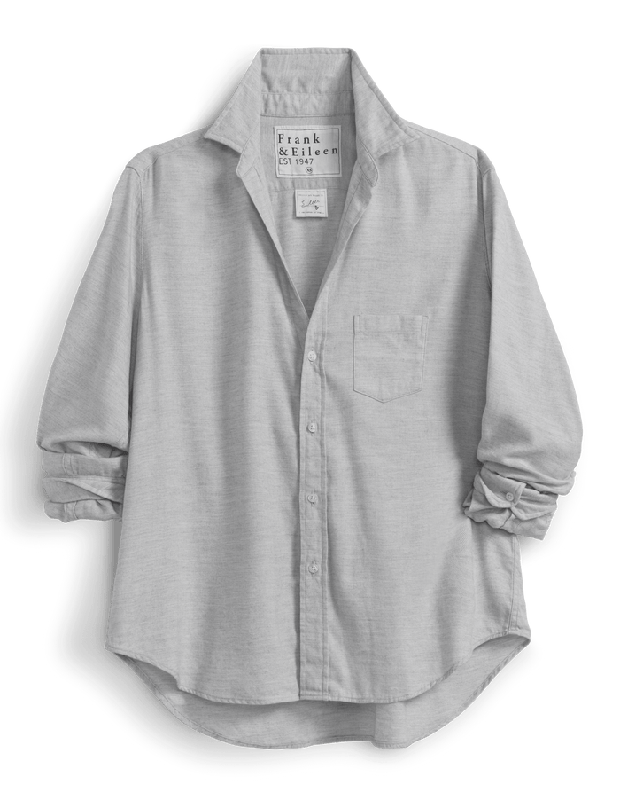 Light gray button-up shirt with rolled-up sleeves on a green background
