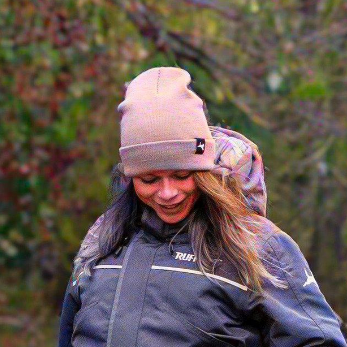 Lady wearing a light pink winter toque beanie