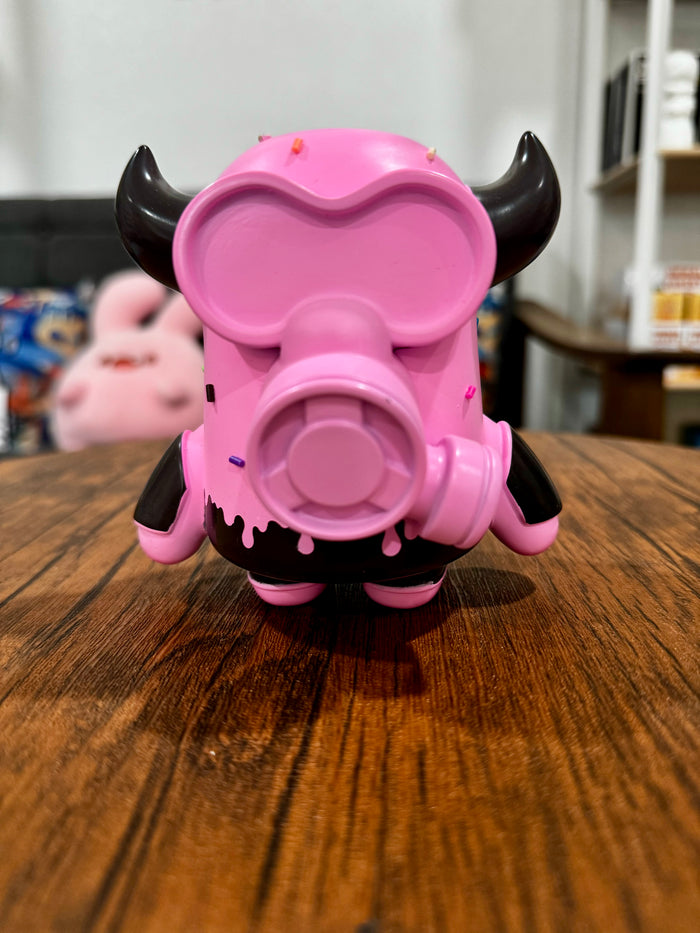 MASK BULL StrawBerry Spray Chocolate by CO2, a pink and black sofubi toy, 11.5cm tall, displayed on a wooden surface.