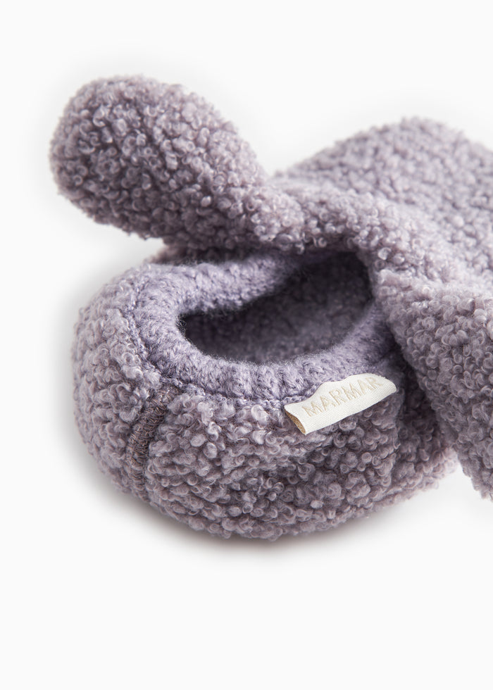 Pink teddy baby shoes with an open heel edge and a small tag on the side.