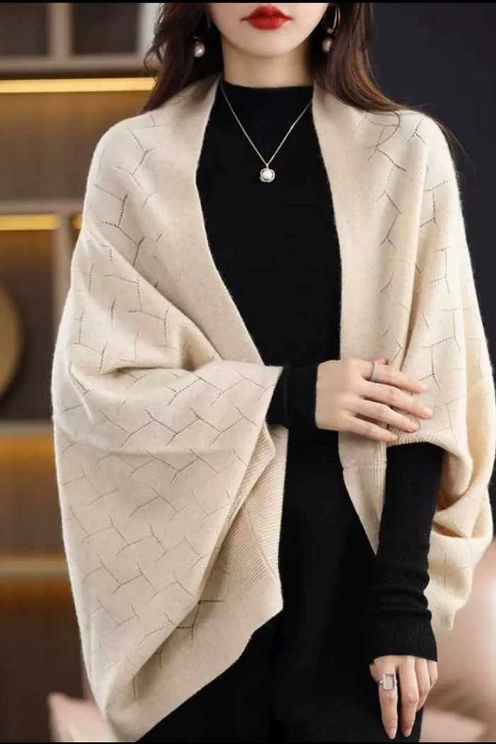 Beige Peony travel cardigan wrap draped over a surface, showcasing soft fabric and versatile design for comfortable travel wear.
