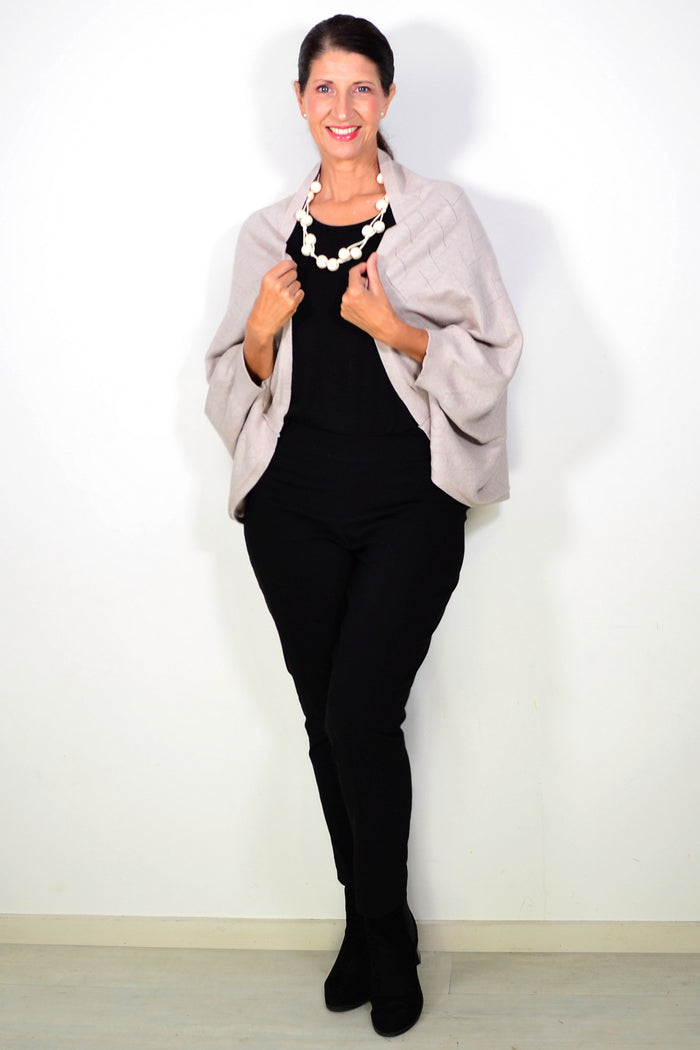 Beige Peony travel cardigan wrap with soft, cozy fabric, draped elegantly showing its relaxed fit and versatile style.