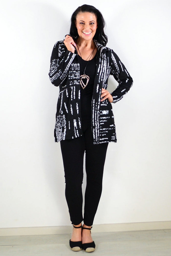 Black and white Hourglass tunic shirt jacket with a classic collar and long sleeves, styled for casual or layered outfits.