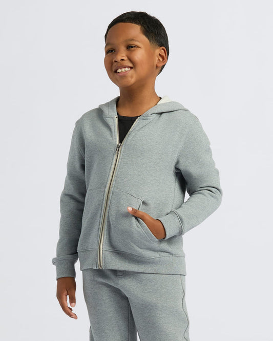 Boy wearing Boys' Medium Heather Gray Fleece Full Zip Hoodie, smiling.