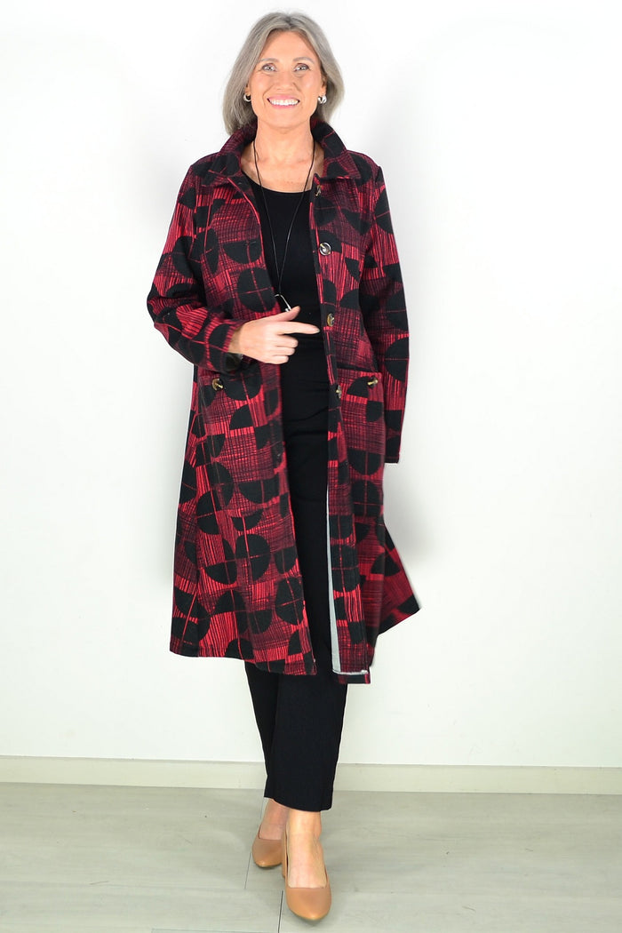 Brick red and black fleece-lined tunic jacket by Hourglass, featuring a cozy, stylish design with visible fleece interior and tailored fit.