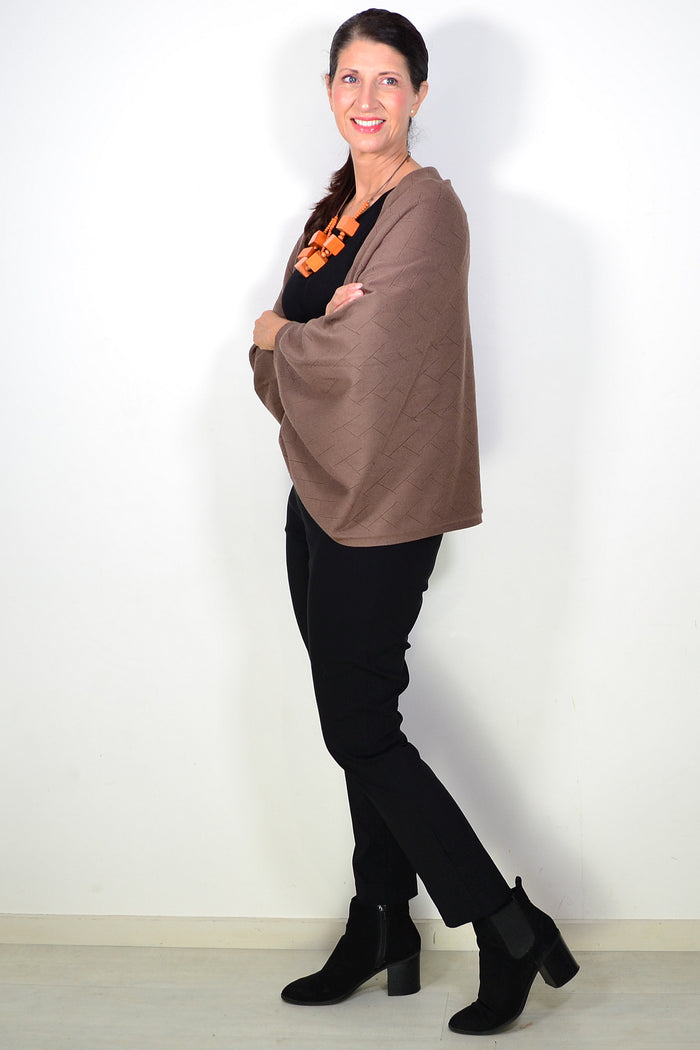 Peony brown travel cardigan wrap draped over a chair, soft and cozy fabric ideal for travel comfort and layering.