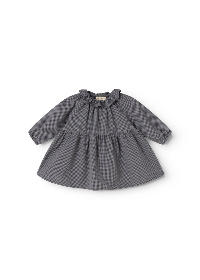 Dark patterned dress with long sleeves and a pleated collar at the neckline.