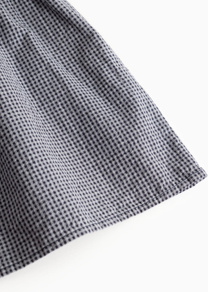 Blue-gray checkered sleeve with straight seam and lightly pleated cuff.