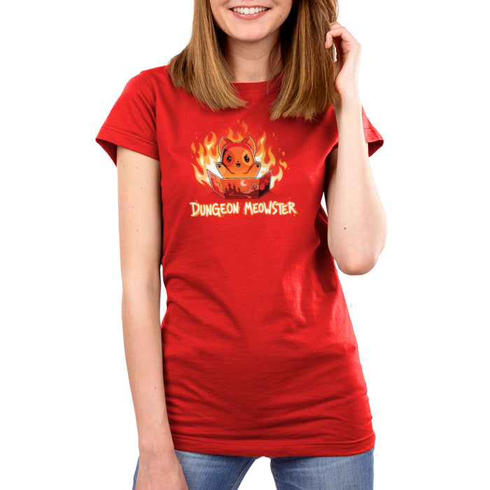 Premium Cotton T-shirt_TeeTurtle Dungeon Meowster garnet red apparel featuring a cartoon red cat surrounded by flames with an evil look on its face  holding a book that has a castle, moon and trees on the cover with Dungeon Meowster written underneath.