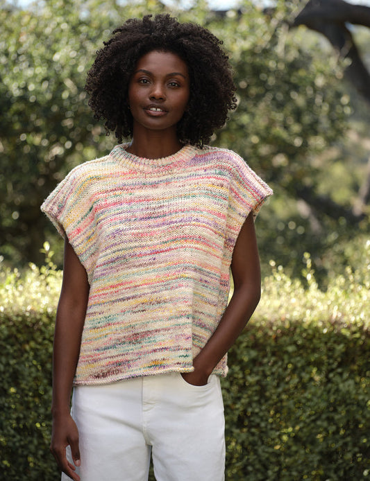 Woman wearing a colorful knitted sleeveless sweater outdoors