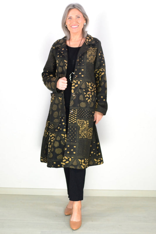 Black fleece-lined tunic jacket by Hourglass, featuring a long black tan design and cozy fleece interior.