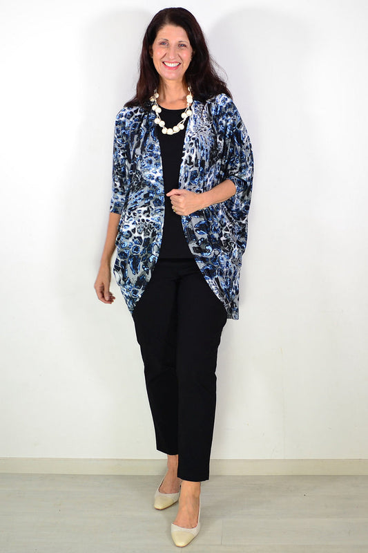 Blue animal print long sleeve cardigan by Lilia Whispers, styled as a cozy tunic with vibrant pattern and soft knit fabric.