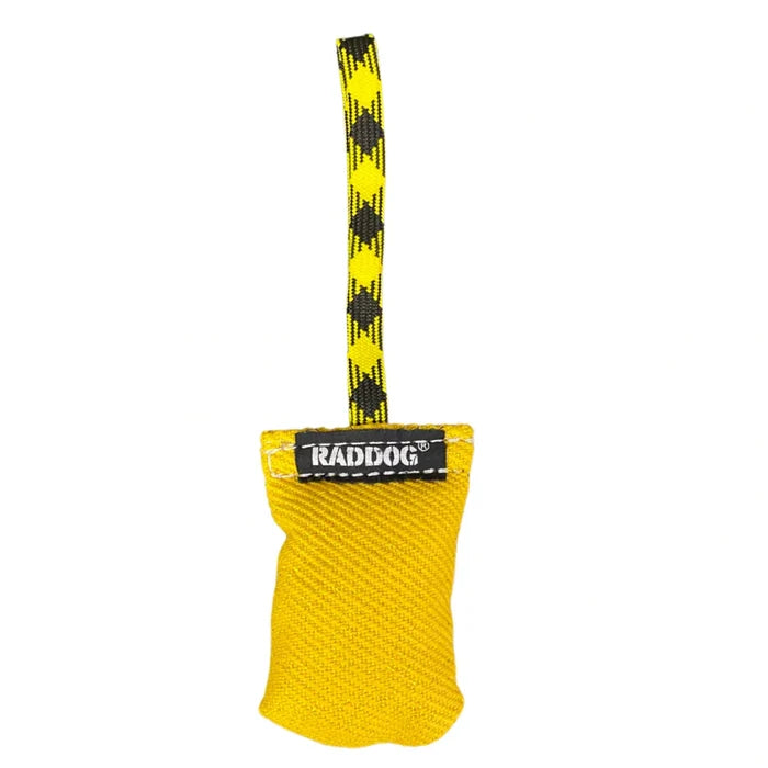 RADDOG small yellow tug toy with textured fabric and a patterned handle, designed for dog training, bite work, and reward play.
