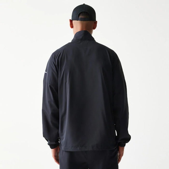 The model is wearing this MLB Reflective Strip New York Yankees Jacket in black. 2