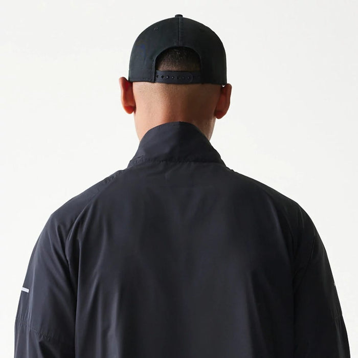 The model is wearing this MLB Reflective Strip New York Yankees Jacket in black. 7