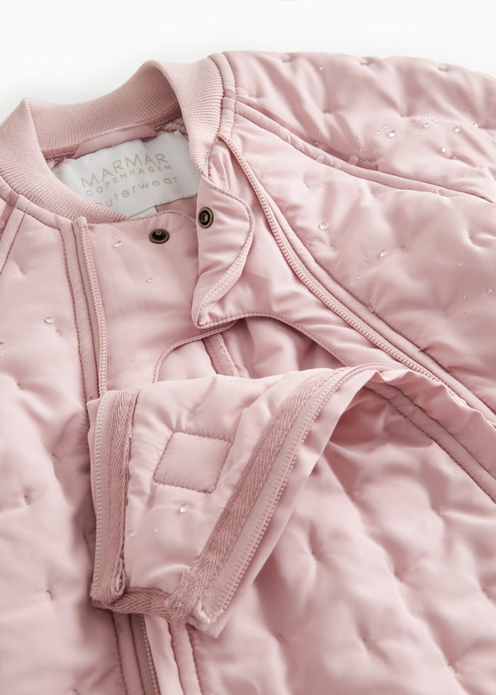 Pink wetsuit with zipper, snap closure, and chest pocket detail.
