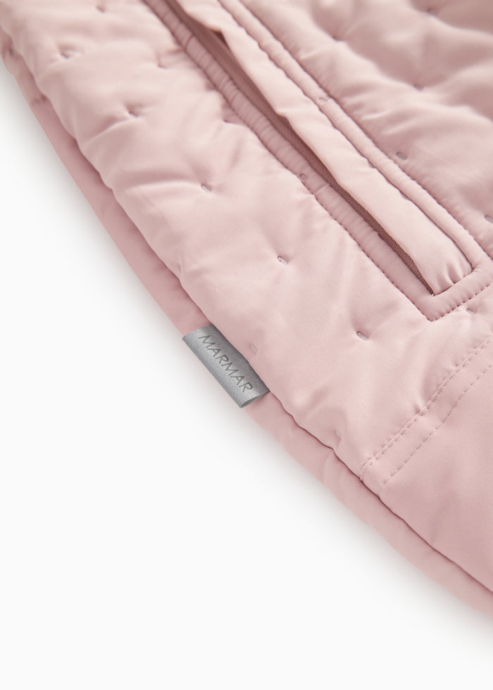 Pink raincoat with quilted pattern and visible seam/edge detail.