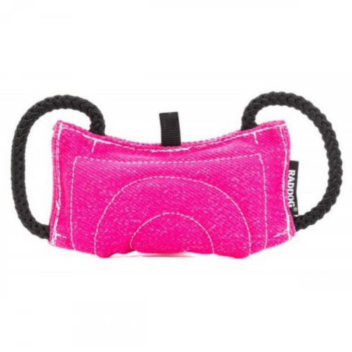 Pink dog training bite tug made of durable textured fabric, featuring reinforced stitching and two black rope handles on each side, isolated on a white background.