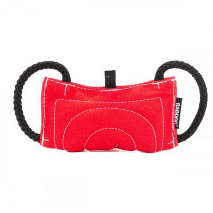 Red green dog training bite tug made of durable textured fabric, featuring reinforced stitching and two black rope handles on each side, isolated on a white background.
