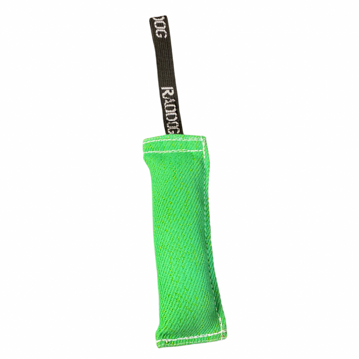 Green cylindrical dog training tug made of durable woven fabric with reinforced stitching, featuring a black loop handle with “RADDOG” branding on one end.
