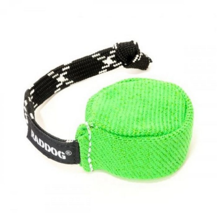 Bright green fabric dog training puck with a textured woven surface and a black braided handle featuring white “RADDOG” branding, isolated on a white background.