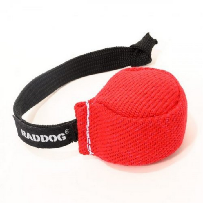 Red fabric dog training puck with a textured woven surface and a black braided handle featuring white “RADDOG” branding, isolated on a white background.