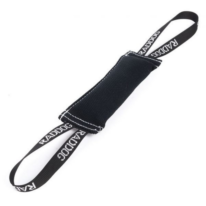 Black dog training tug toy made of durable fabric with white stitching and two loop handles labeled “RADDOG,” isolated on a white background.