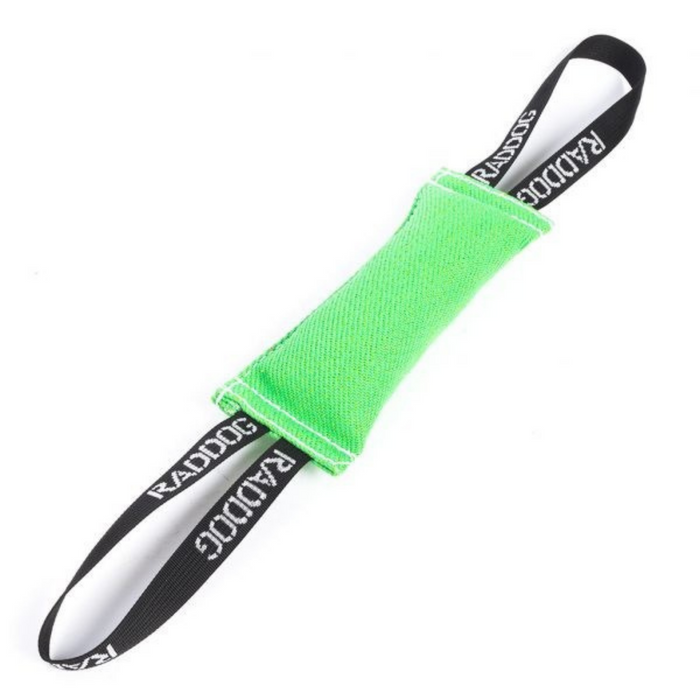 Green dog training tug toy made of durable fabric with white stitching and two black loop handles labeled “RADDOG,” isolated on a white background.