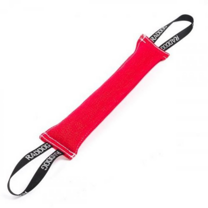 Red dog training tug toy made of durable fabric with reinforced stitching, featuring black loop handles on both ends with “RADDOG” branding.