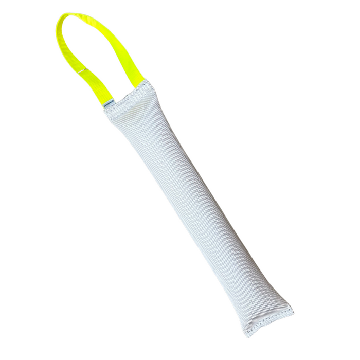 White dog training dummy toy with yellow handle on plain background