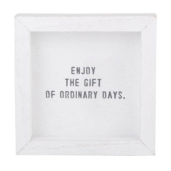 White wooden sign with the phrase “Enjoy the gift of ordinary days” — inspirational home décor piece from The Pink Doxie Boutique.