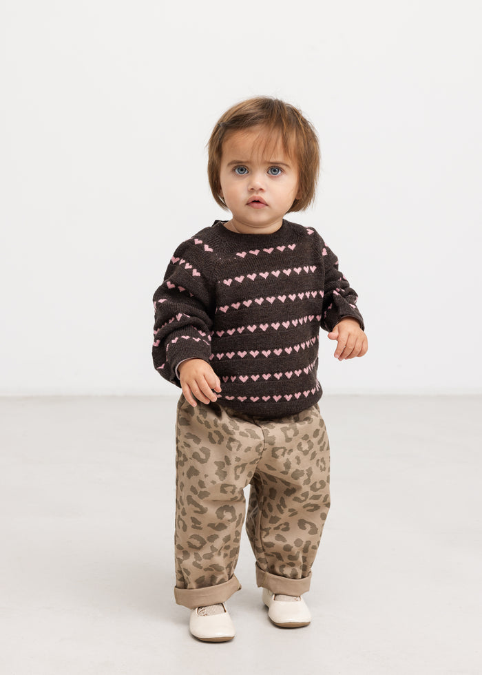 Sort striped blouse with pink hearts, shown on model